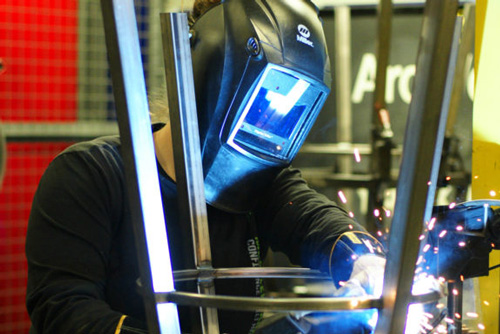 Welder making a bar stool frame.